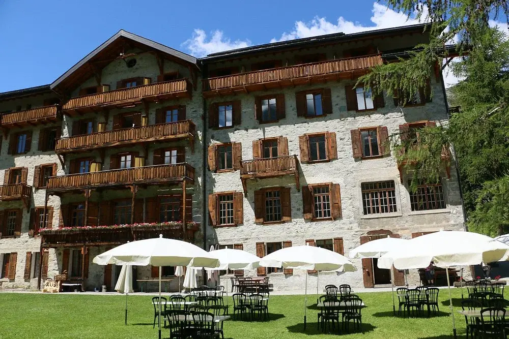 Garden of the Grand Hôtel & Kurhaus in summer, facing the stone-pine forest and the peaks