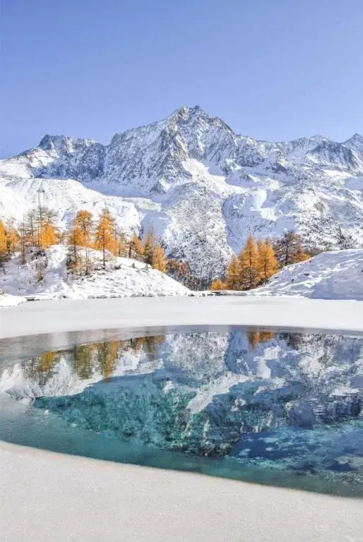 The frozen lake of Arolla under snow in winter