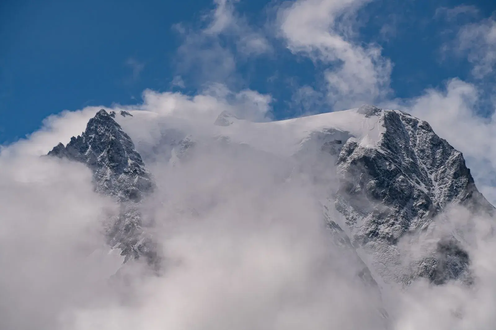 Panorama of the snow-capped peaks around Arolla, among the clouds
